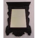 A carved shaped rectangular mahogany framed hall mirror, 72 x 57cm
