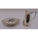 A silver cream jug of conical form with scroll handle on circular spreading base, London 1927 by