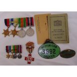 A quantity of WWII medals to include miniatures, national registration identity card and two green