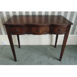 A mahogany serpentine fronted hall table the three drawers with brass swing handles on four tapering