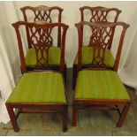 Four mahogany dining chairs with scroll pierced backs, upholstered seats on four rectangular legs