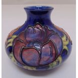 Moorcroft squat vase blue ground decorated with anemone, marks to the base, 10cm (h)