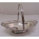 A George III silver fruit bowl, oval, leaf and floral engraved with reeded borders and swing