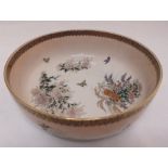 An oriental bowl decorated with butterflies, flowers and leaves, 22.5cm (d)