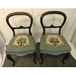 A pair of Victorian mahogany balloon back occasional chairs with tapestry seats on cabriole legs,