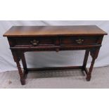A 19th century oak consol table with two drawers with hinged swing handles, 76 x 106.5 x 30cm
