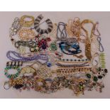A quantity of costume jewellery to include necklaces, bracelets, earrings, brooches and pendants