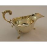 A silver sauce boat with scroll handle on three pad feet, Birmingham 1931, approx total weight 94g