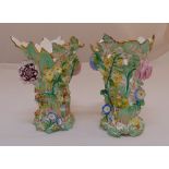 A pair of continental vases decorated with applied flowers and leaves, 17cm (h)