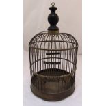 A 19th century brass bird cage, cylindrical, hinged door, brass swing and feeders with turned