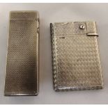 An engine turned silver cigarette lighter and a Dunhill cigarette lighter