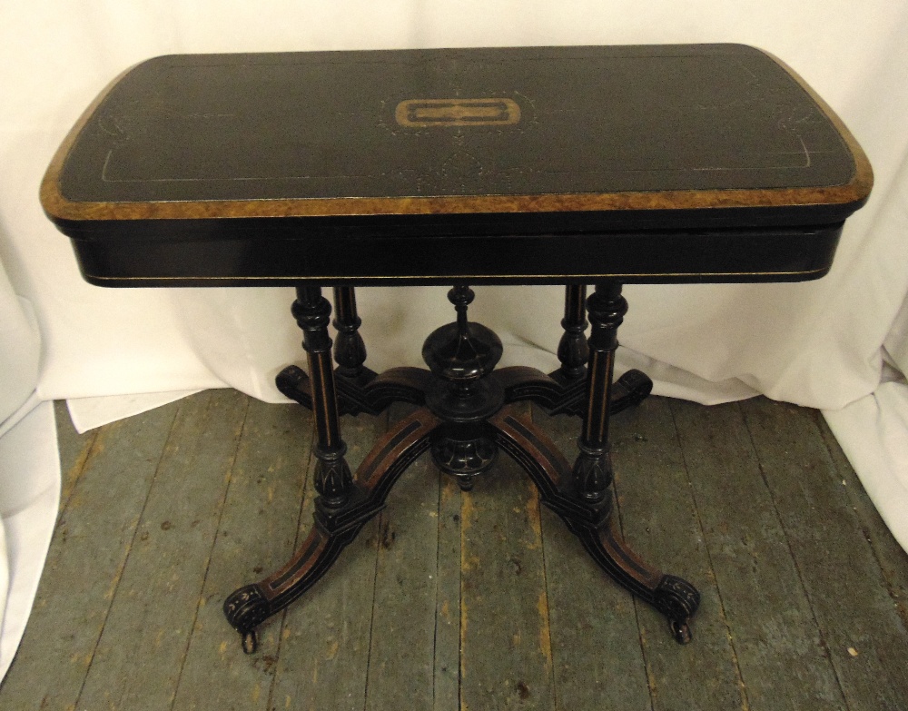 A Victorian ebonised games table on four outswept legs, 73 x 92 x 45cm