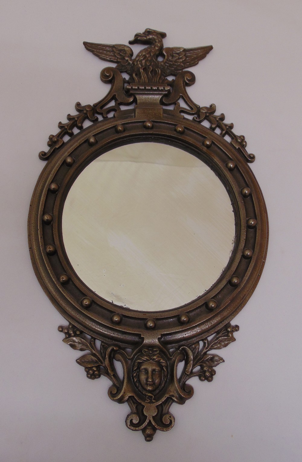 A 19th century style cast metal wall mirror, 50 x 28.5cm