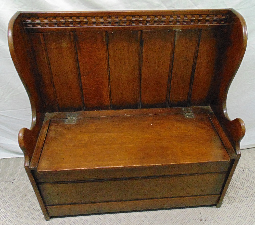 An oak Monks bench with panelled back and hinged seat, 91.5 x 90.5 x 42cm