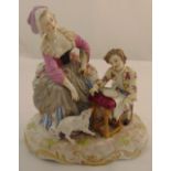 A continental figural group of a lady with a boy and a dog, 22.5 x 23 x 12.5cm