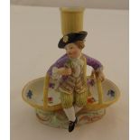 Meissen figural salt and candle holder with a figurine of a seated boy holding flowers, marks to the