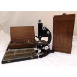 A cased Beck microscope circa 1940 and two wooden cases with pre prepared slides, approx 200 slides