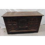 A 19th century oak blanket box the front and sides carved with flowers and scrolls, hinged cover, on