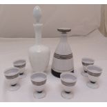 An Art Deco white milk glass decanter and six matching liqueur glasses and another decanter with