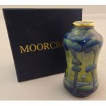 Moorcroft enamel limited edition vase 74/200 decorated with blue trees in a landscape, marks to