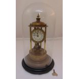 A brass skeleton clock, white enamel dial, Arabic numerals, mounted in a glass dome to include key