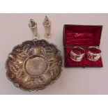 Continental white metal dish on three scroll feet, a pair of pepperettes and a cased set of two