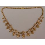 A Victorian gold, diamond and seed pearl necklace set with seven diamonds and pearl clusters with