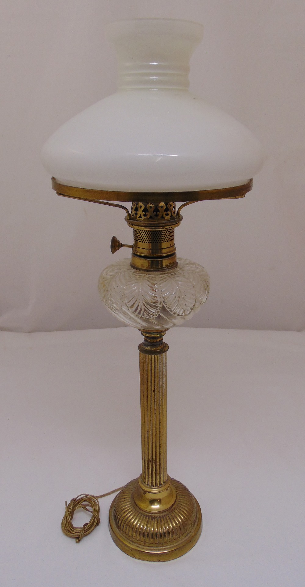 A Victorian brass oil lamp with frosted shade converted to an electric table lamp, 68.5cm (h)