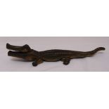 A brass nutcracker in the form of a crocodile, 36cm (w)