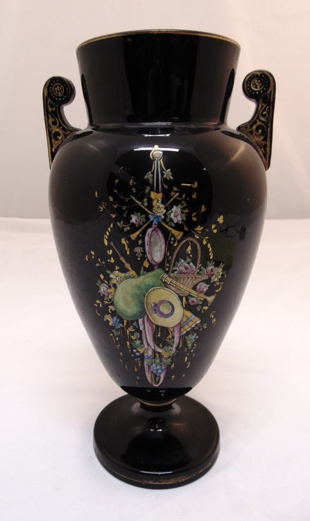 A late Victorian black glass baluster vase decorated with a hand painted scene 30cm (h)