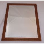 A rectangular bevelled wall mirror in a walnut veneered frame, 68 x 58 cm