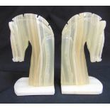 A pair of hardstone bookends in the form of horses heads, 18cm (h)