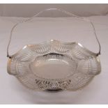 A silver fruit basket with pierced sides, swing handle on pierced circular base, Sheffield 1964,