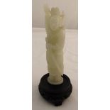A white jade carved figurine of a warrior holding sword 13.5cm (h) to include pierced wooden base
