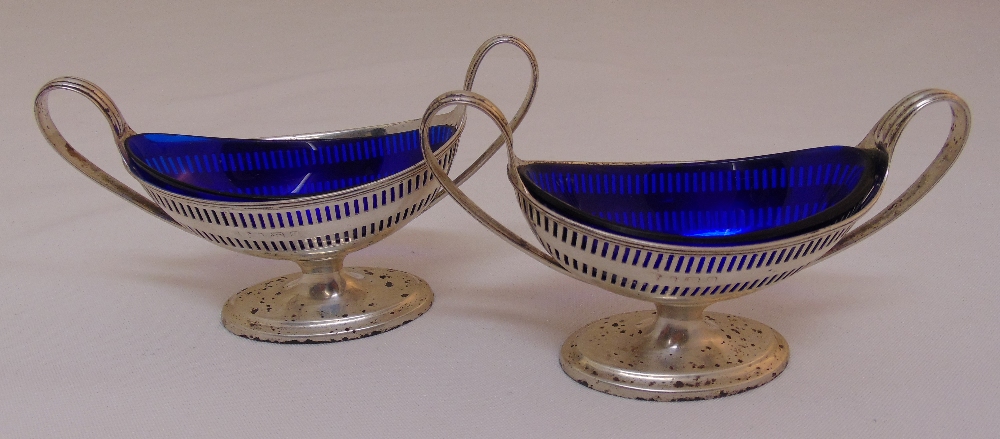 A pair of oval salts with blue glass liners, marks rubbed, approx total weight of silver 175g