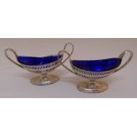 A pair of oval salts with blue glass liners, marks rubbed, approx total weight of silver 175g