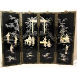A set of four oriental Mother of Pearl and ebonised hardwood wall hangings depicting figures in an