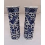 A pair of 19th century Chinese blue and white vases of tubular form with everted rims, decorated