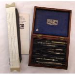 A cased set of draughtsmans instruments and a slide rule
