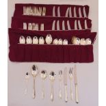An eight place setting of Heritage silver plated flatware to include knives, forks and spoons