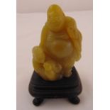 A Chinese hardstone figurine of a happy Buddha and child on square wooden stand, 10 x 6 x 5cm