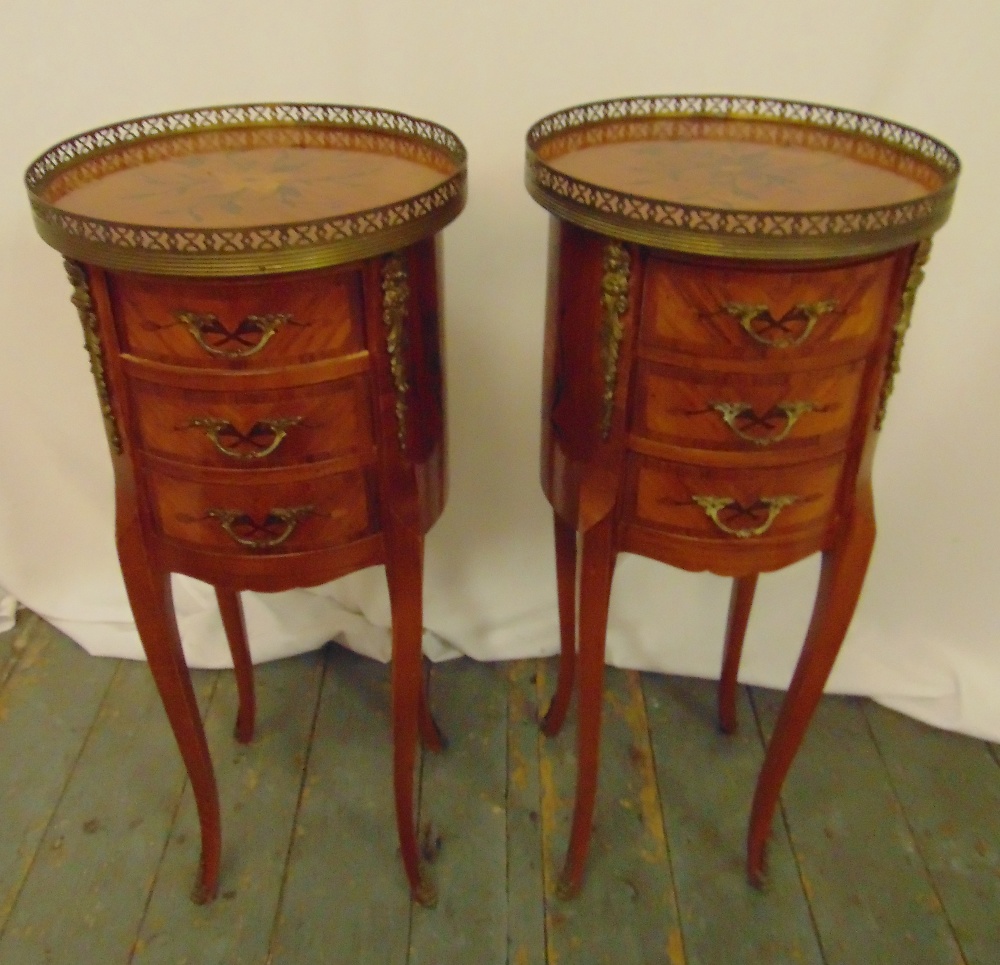 A pair of French style cylindrical three drawer side tables with pierced gallery tops on cabriole