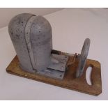 An early 20th century milliners hat stretcher on shaped rectangular wooden base, 32 x 53.5 x 22cm