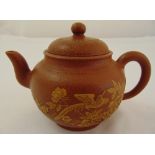 A Chinese Yixing teapot decorated with birds flowers and leaves to the side, marks to the base, 11 x
