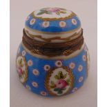 A Sevres circular covered inkwell decorated with floral sprays and domed hinged cover, marks to