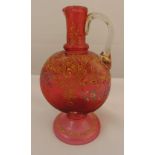A continental cranberry glass ewer, hand painted with scrolls, flowers and leaves on raised circular
