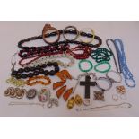 A quantity of costume jewellery to include necklaces, rings, brooches, bracelets and an amber