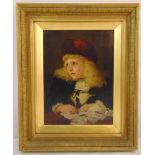 A framed oil on canvas portrait of a young girl seated at a desk, indistinctly signed bottom left,