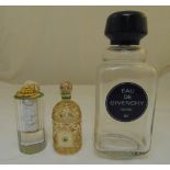 Three glass display perfume containers to include Eau de Givency and Guerlain, tallest 37cm (h)