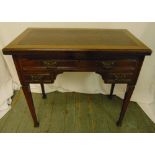 A mahogany rectangular kneehole desk, the three drawers with brass handles on four tapering